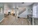 Spacious home entryway featuring wood-look floors, staircase, and contemporary design at 8073 Villa Pulido St, Las Vegas, NV 89131