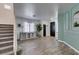 Inviting entryway showcasing staircase, wood-look floors, and decorative wall accents at 8073 Villa Pulido St, Las Vegas, NV 89131