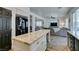 Open kitchen featuring granite countertops, an island, and seamless living area access at 8073 Villa Pulido St, Las Vegas, NV 89131