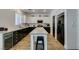 Bright and modern kitchen with black appliances, white cabinets, and a center island at 8073 Villa Pulido St, Las Vegas, NV 89131