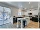 Modern kitchen with marble countertops, island, and access to backyard patio at 8073 Villa Pulido St, Las Vegas, NV 89131