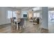 Open-concept dining and living area with wood-look flooring and elegant chandelier at 8073 Villa Pulido St, Las Vegas, NV 89131