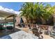 Inviting pool area with covered patio, fire pit, and lush landscaping at 8073 Villa Pulido St, Las Vegas, NV 89131