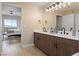 Modern primary bathroom with wood vanity, double sinks, and doorway to main bedroom at 8255 Las Vegas Blvd # 802, Las Vegas, NV 89123