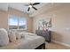 Bright bedroom with ceiling fan, dresser, and a view of the mountains in the distance at 8255 Las Vegas Blvd # 802, Las Vegas, NV 89123