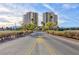 Exterior view of twin high-rise condo towers with a paved entranceway and desert landscape at 8255 Las Vegas Blvd # 802, Las Vegas, NV 89123