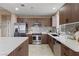 Modern kitchen with stainless steel appliances, island, and wood cabinets at 8255 Las Vegas Blvd # 802, Las Vegas, NV 89123
