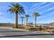 Well-maintained landscaping with palm trees and signage at the property entrance at 8255 Las Vegas Blvd # 802, Las Vegas, NV 89123