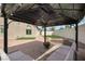 Backyard with a cozy gazebo, outdoor seating, and a fire pit, perfect for relaxing and entertaining at 8287 Lincoln Valley St, Las Vegas, NV 89123