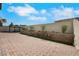 A paved backyard featuring a gazebo, manicured shrubs, and a privacy wall, offering a serene outdoor setting at 8287 Lincoln Valley St, Las Vegas, NV 89123
