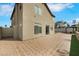 Rear elevation featuring brick paved patio and green landscaping, ideal for outdoor activities at 8287 Lincoln Valley St, Las Vegas, NV 89123
