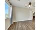 Bedroom featuring light walls, wood floor, ceiling fan and bright window at 8287 Lincoln Valley St, Las Vegas, NV 89123