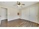 Spacious bedroom with hardwood floors, ceiling fan, closet, and a connecting door at 8287 Lincoln Valley St, Las Vegas, NV 89123