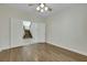 Bedroom with wood floors and large doorway to hallway with stairs at 8287 Lincoln Valley St, Las Vegas, NV 89123