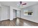 Bright bedroom with wood floors, mirrored closet, and ceiling fan at 8287 Lincoln Valley St, Las Vegas, NV 89123