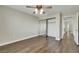 Neutral bedroom featuring a ceiling fan, wood floors, and a mirrored sliding-door closet at 8287 Lincoln Valley St, Las Vegas, NV 89123