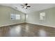 This bright bedroom features hardwood floors, vaulted ceilings, and multiple windows at 8287 Lincoln Valley St, Las Vegas, NV 89123