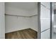 A walk-in closet with hardwood floors and white walls, providing ample storage space at 8287 Lincoln Valley St, Las Vegas, NV 89123