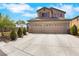 Eye-catching exterior of a well-maintained home complete with a three-car garage and landscaped front yard at 8287 Lincoln Valley St, Las Vegas, NV 89123