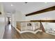 Bright hallway featuring hardwood floors and wood railing overlooking the floor below at 8287 Lincoln Valley St, Las Vegas, NV 89123