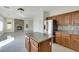 Bright kitchen with island, stainless appliances, and access to fireplace room at 8287 Lincoln Valley St, Las Vegas, NV 89123