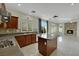 Bright kitchen with island, stainless appliances, and access to fireplace room at 8287 Lincoln Valley St, Las Vegas, NV 89123