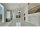Bright living room with custom shelving and shuttered windows, staircase and balcony at 8287 Lincoln Valley St, Las Vegas, NV 89123