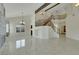 Bright and expansive living room with tile floors, high ceilings, and an elegant staircase, offering ample space at 8287 Lincoln Valley St, Las Vegas, NV 89123