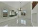 Bright living room with modern chandelier, custom shelving and shuttered windows at 8287 Lincoln Valley St, Las Vegas, NV 89123