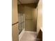 Bathroom featuring a shower with glass doors and tan walls at 830 Carnegie St # 1811, Henderson, NV 89052