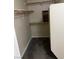 Spacious walk-in closet equipped with multiple wooden shelving units, and carpet flooring at 830 Carnegie St # 1811, Henderson, NV 89052