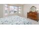 Bedroom with a bay window letting in natural light, complemented by a vintage-style dresser at 8904 Marble Dr, Las Vegas, NV 89134