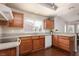 Well-lit kitchen features wood cabinets, granite countertops, and modern appliances at 8904 Marble Dr, Las Vegas, NV 89134
