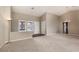 Bright living room featuring neutral carpeting, vaulted ceilings, and multiple windows for natural light at 8904 Marble Dr, Las Vegas, NV 89134