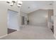 Bright, carpeted living room featuring vaulted ceilings and access to other areas of the home at 8904 Marble Dr, Las Vegas, NV 89134