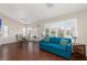 Cozy living area with bright windows, with wood floors, and a comfortable blue sofa at 8904 Marble Dr, Las Vegas, NV 89134