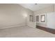 Carpeted living room with high ceilings, featuring a tiled entryway and multiple windows at 8904 Marble Dr, Las Vegas, NV 89134