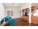 Inviting living room featuring hardwood floors, built-in shelving and natural light from the shuttered windows at 8904 Marble Dr, Las Vegas, NV 89134