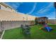 Backyard featuring a pergola, artificial grass, and seating area with space for recreation at 10004 Pasque Flower Ct, Las Vegas, NV 89178