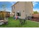 Spacious backyard with artificial turf, pergola, dining set, and ample space for outdoor living at 10004 Pasque Flower Ct, Las Vegas, NV 89178