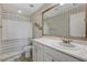 Clean bathroom featuring a shower-tub combination, vanity with sink, and decorative wallpaper at 10004 Pasque Flower Ct, Las Vegas, NV 89178
