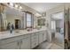 Bathroom showcasing a double sink vanity, attractive mirrors, and neutral finishes at 10004 Pasque Flower Ct, Las Vegas, NV 89178