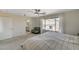 Bright bedroom showcasing a queen bed, neutral carpet, and a view of the neighborhood at 10004 Pasque Flower Ct, Las Vegas, NV 89178
