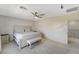 Neutral bedroom showcasing a queen bed, bench, carpet, and ceiling fan at 10004 Pasque Flower Ct, Las Vegas, NV 89178