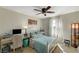 Cozy bedroom with a full-sized bed, desk, and bright window providing natural light at 10004 Pasque Flower Ct, Las Vegas, NV 89178