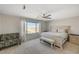 Bright bedroom featuring a queen bed, neutral carpet, and window with views at 10004 Pasque Flower Ct, Las Vegas, NV 89178