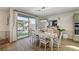 Bright dining area with a wooden table, chairs, and sliding glass door to the backyard at 10004 Pasque Flower Ct, Las Vegas, NV 89178