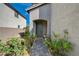 Inviting front entrance with beautiful landscaping leading to a charming green door at 10004 Pasque Flower Ct, Las Vegas, NV 89178