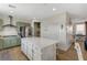 Spacious kitchen featuring green cabinets, stainless steel appliances, and an island with a white stone countertop at 10004 Pasque Flower Ct, Las Vegas, NV 89178