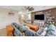 Cozy living room with a large sectional sofa, TV, and staircase at 10004 Pasque Flower Ct, Las Vegas, NV 89178